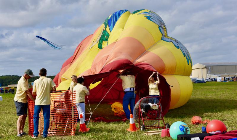 The On Your Way Up team uses fans to partially inflate its balloon in order to allow people to walk inside.