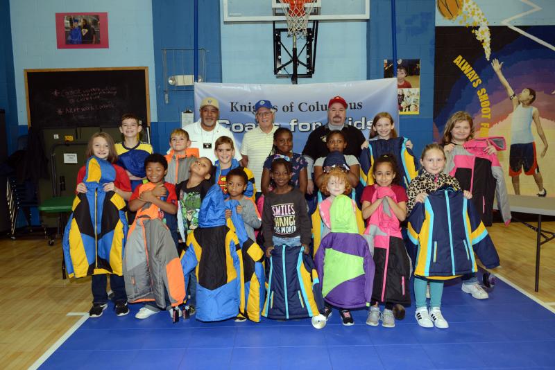 Oak Orchard Boys & Girls Club members are happy with their new coats provided by the Knights of Columbus. Shown in back are (l-r) Grand Knight Robert Oliver, Tom Keating and Deputy Grand Knight Frank Emmi. In the second row are Isaiah Cooney, Chris Potter, Nate Potter, Logan Potter, Keysha Taylor, Brooklyn Daniels, Violet Cooney and Dana Burke. In front are Noah Gibbs, DeWayne Hopkins, Kayden Lindsay, Zakiyah Lazarus, Fiona Dordell, Alexandria Amero and Abby Eroh. Coats for Kids