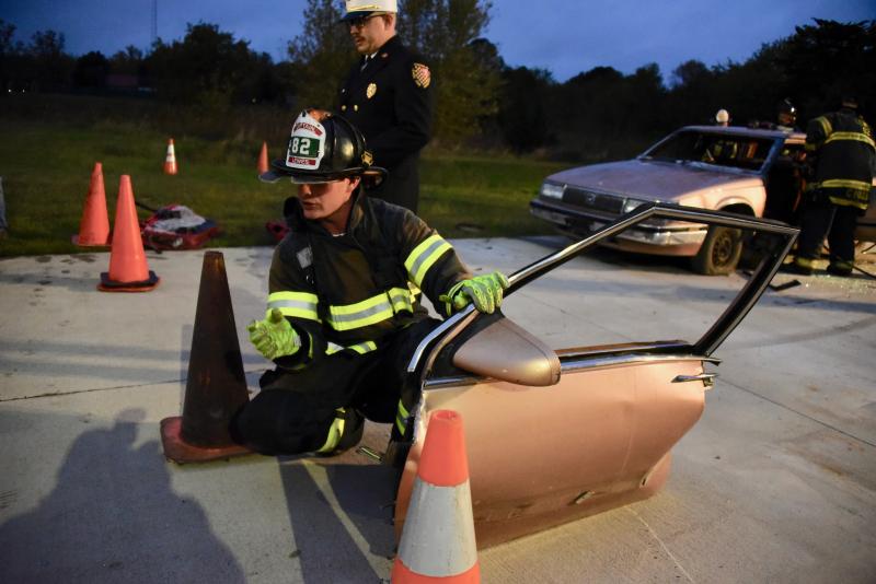 Lewes Fire Capt. Christopher Colpo shows the crowd a door that was just removed during an extrication demonstration.