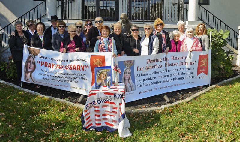 About 20 people joined at St. Edmond to pray the rosary. Shown are (l-r) Evelyn Culver, Kathy Counts, Maryanne Vines, Don Vines, Barbara Hagey, Rhona Prescott, Joan Condon, Bridget Touhey, Dolly Mall, Lillian Reynolds, Terri Cassanelli, a statue of Jesus and the Children, Terry Palumbo, Theresa Treglia, Dolly Grazioli, Joan Brohawn, Josie Cilea, Virginia Pocock, and Becky Riley. Jesus and the Children is dedicated to all children living and deceased and aborted. Father Raymond Forrester approved statue at the request of the Respect Life Ministry. The first statue was destroyed by vandals and had to be replaced.