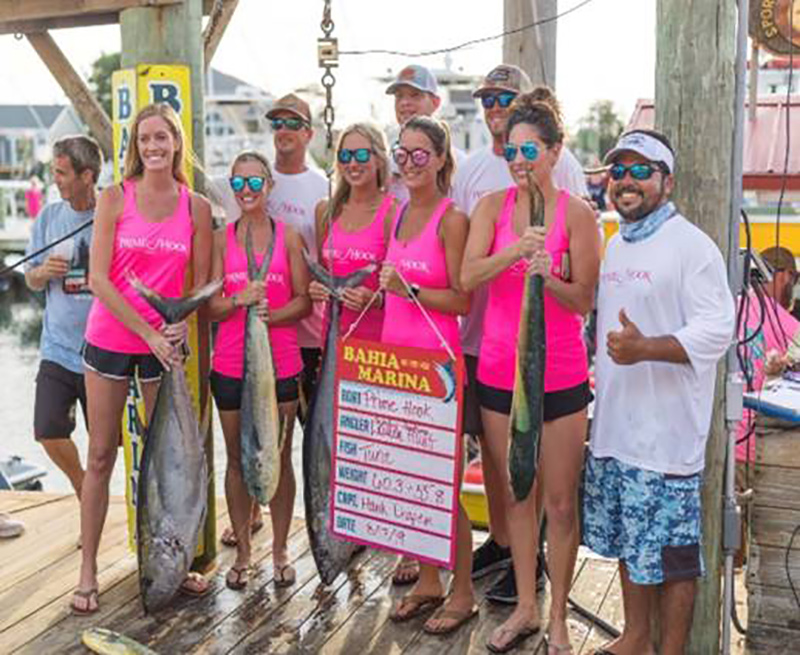Ashleigh Hudson, far left, with the tuna she caught at Ocean City’s Poor Girls Open in August, 2019.