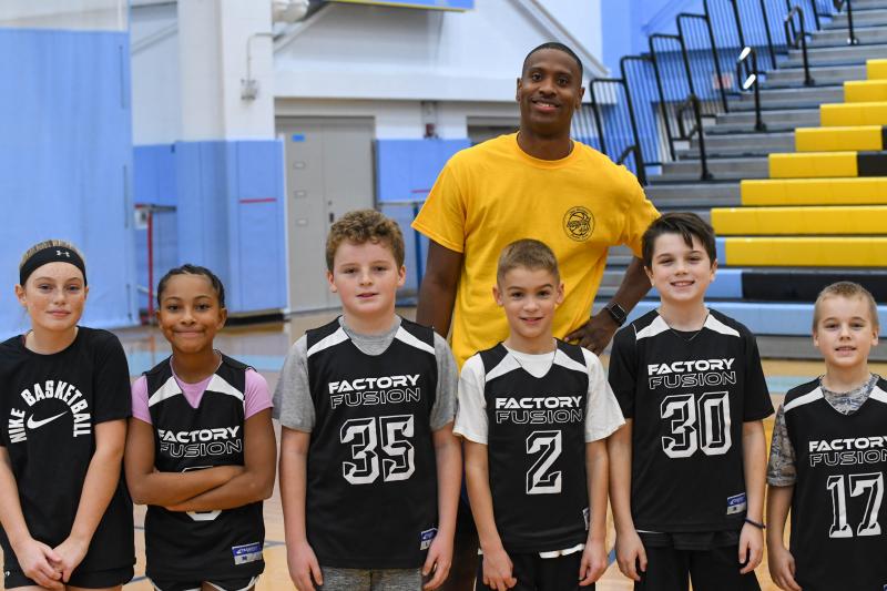 Coach Jordan Howell shows off the Black team. Shown in front are (l-r) Mya Yngve, Journey McDaniel, Liam Crotty, Nathan Re, Dominic Siedor and Nehemiah Woods.