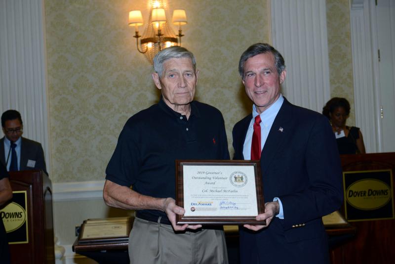Monarch butterfly enthusiast retired Army Col. Michael McFarlin initiated and directed the Monarch Highway Habitat project. McFarlin is shown accepting his award from Gov. John Carney. Gov. Volunteer Award