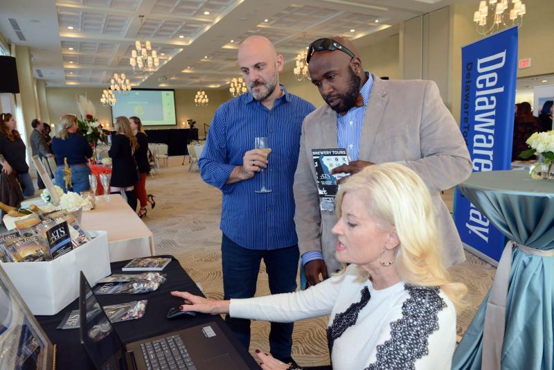 David Molotsky, left, and Michael Freshwater talk with Denise Bernardo about some of the vehicles offered by Atlantic Transport Services. Wedding give away