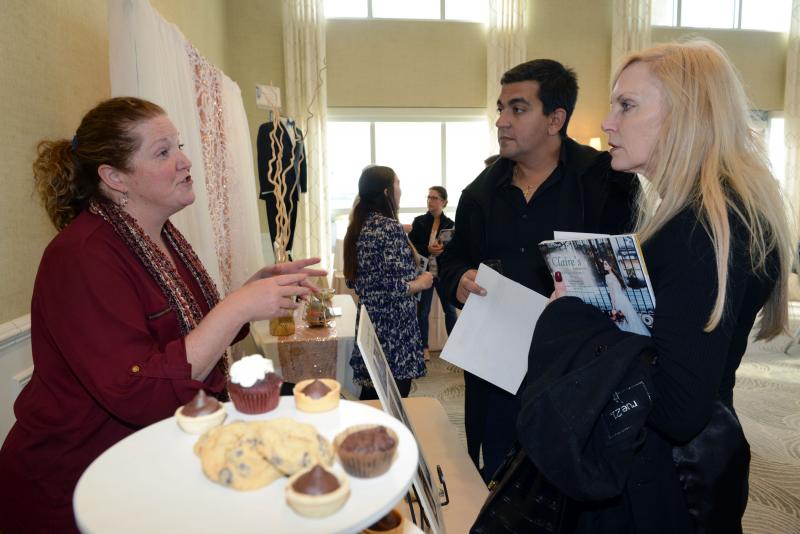 Jen Rineer, left, owner of Carolina Sugar Factory, describes her service to Dan Passante and Debbie Sypeck. Wedding give away
