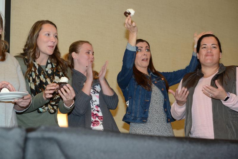 Alyssa Mahon of Frankford raises her winning cupcake at the Wedding Giveaway event. She is surrounded by almost-winners (l-r) Rachael Scott, Kelsey Arnold, and Sonia Trudeau. Wedding give away