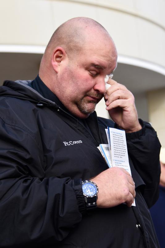 The Rev. William Cocco is overcome with emotion as he starts praying the rosary. RON MACARTHUR PHOTO