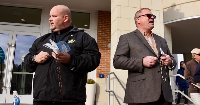 The Rev. William Cocco, left, and Jake Smith, a local radio host, lead the rosary in front of Rehoboth Beach City Hall. RON MACARTHUR PHOTO