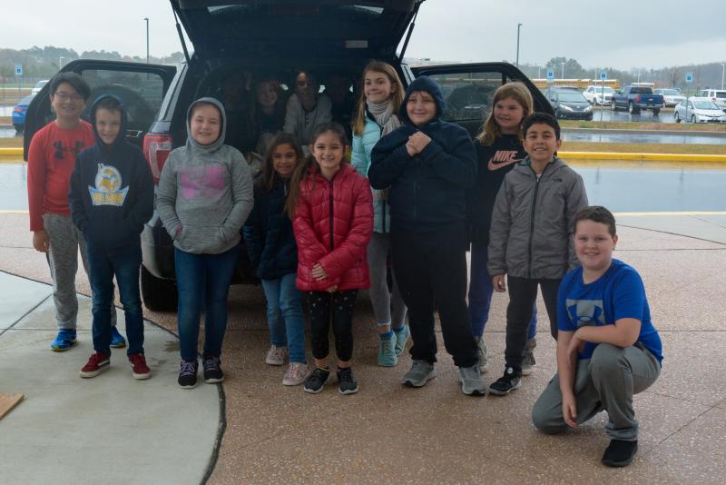 Love Creek CAP students shown in the van are (l-r) Briana Vargas, Jack Simeone, Sophia Anemone, Caleb Marcus, Izzy Kelly-Conaway and Madelyn Klemkowski. In front are Shouta Sano, Owen Beitzel, Sienna Smith, Delaney Long, Vanessa Marshall-Rivera, Ella Williamson, Noah Smith, Molly Meredith, Aaron Guandigue-Flores and Alex Muncie. SUBMITTED PHOTOS