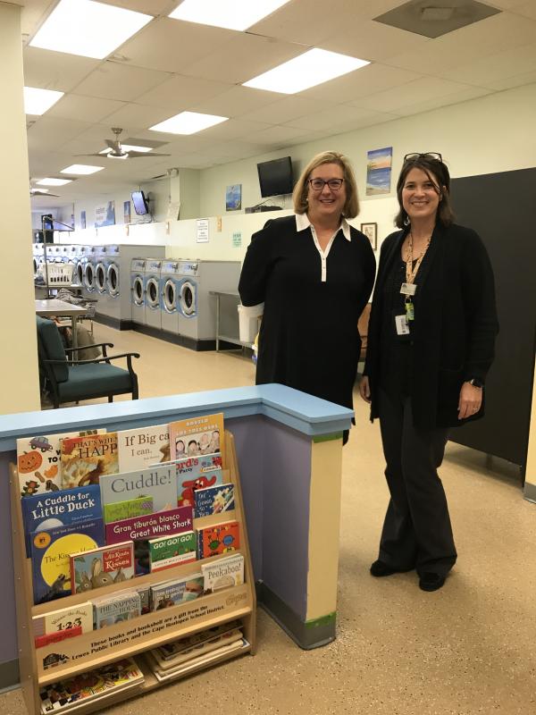 Delivering books and the bookshelf for the children's area at Ocean Suds II are Donna Kolakowski, left, and Jennifer Noonan.