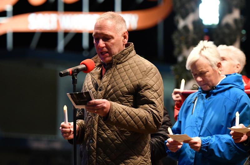 Karl Zoric reads “Tonight we carry a candle to honor the brave activists who would not allow silence to equal death.”