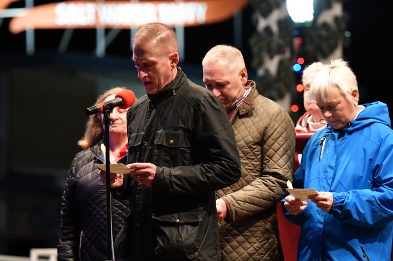 Mark Pipkin reads, “Tonight we rejoice in the progress made in treatment and prevention for HIV.”