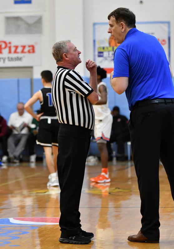 Referee Jim Mahoney gets an earful of colorful language from Gill St. Bernard’s coach Mergin Sina and gives him a technical foul.