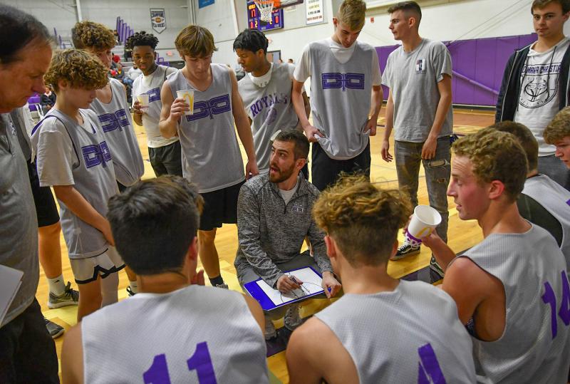 Royals head coach Micah Twedell speaks to his players during a second quarter time out.