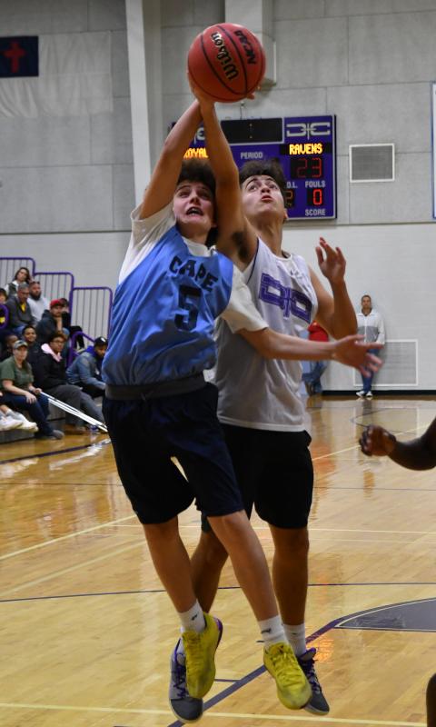 Cape freshman Drew Zimmerman battles for the rebound with Royals forward Nate Moyer.