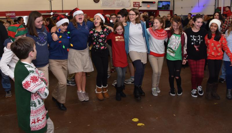 Sussex Academy students get into the spirit of the evening before singing begins.