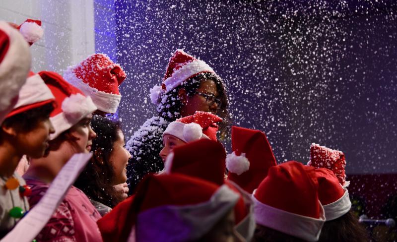 Members of Milton’s Mariner Middle School Choir are covered in “snow” before their performance.