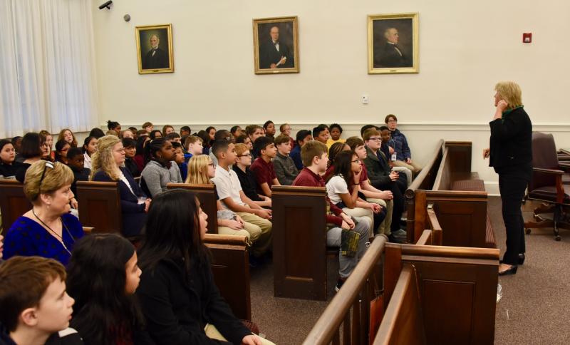 Retired Superior Court Judge Jane Brady tells Lulu Ross Elementary School students from Milford to call out Santa’s name when she touches her ear during the trial.