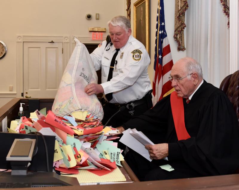 Superior Court Judge Richard Stokes is overwhelmed by the number of letters to Santa Claus that bailiff Tony Summers pours on his desk. He ruled the letters were evidence that Kris Kringle is Santa Claus.