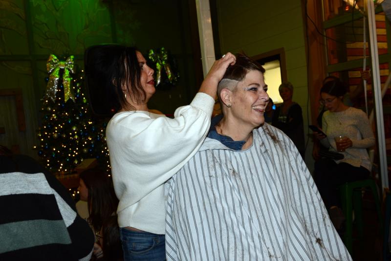 Six-year cancer survivor Anette Rufle gets her hair partially shaved by stylist Chae Sade. Rufle eventually had her whole head shaved. Buzz Off Cancer