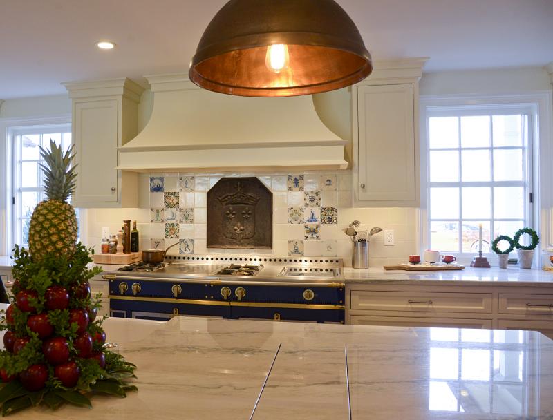 A metal backsplash dated 1667, originally from a French chateau, is the focal point above the kitchen range.