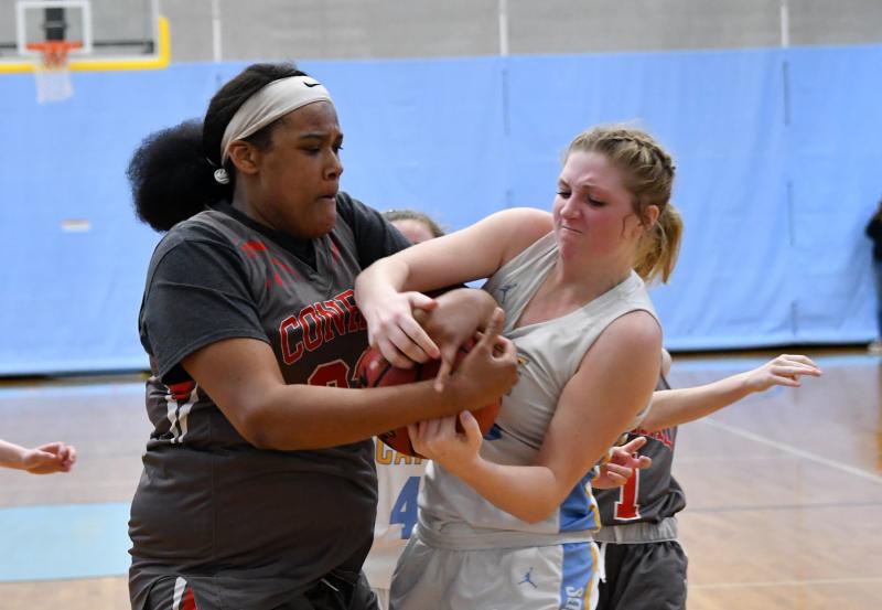 Cape senior Carlin Quinn, right, battles for a rebound with Conrad’s Ja'Nylah Whittlesey.