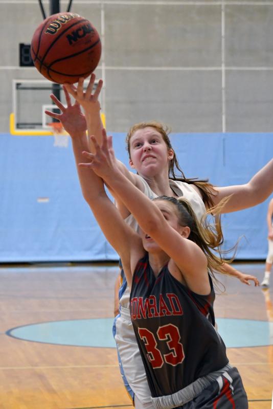 Cape center Abbey Hearn grabs a rebound over Red Wolves player Julie Kulesza.