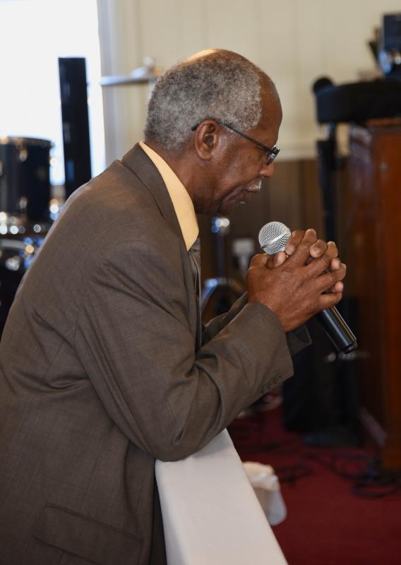 Bruce Duffy, of Faith United Methodist Church in Rehoboth Beach, kneels at the altar to give the innovation.