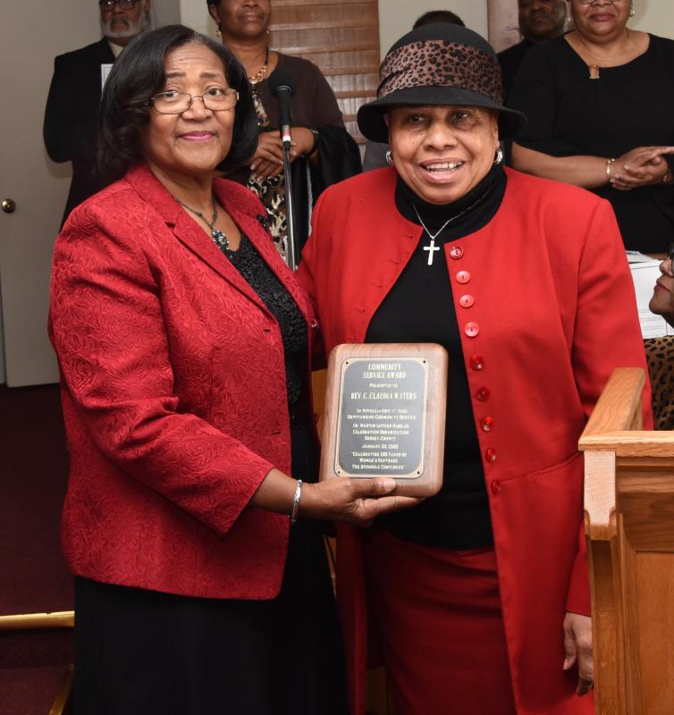 Committee treasurer Janie Miller, left, presents the Community Service Award to the Rev. Claudia Waters, a semi-retired pastor of two churches.