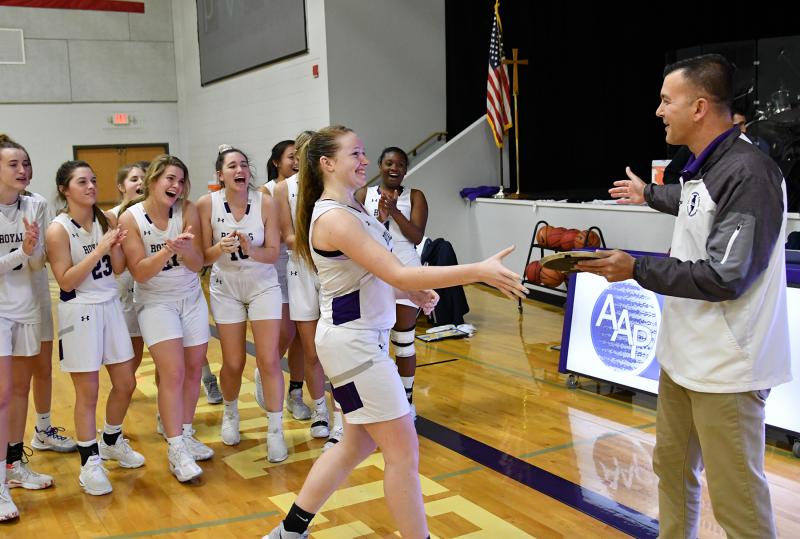 Sophomore Sierra Troyer receives the ESIAC Player of the Year award from Delmarva Christian Athletic Director Jim Berger.