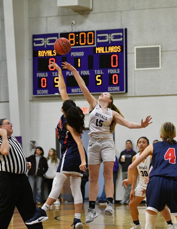 Royals sophomore Sierra Troyer, right, and Mallards junior Christine Lizas go for the tip to start the game.