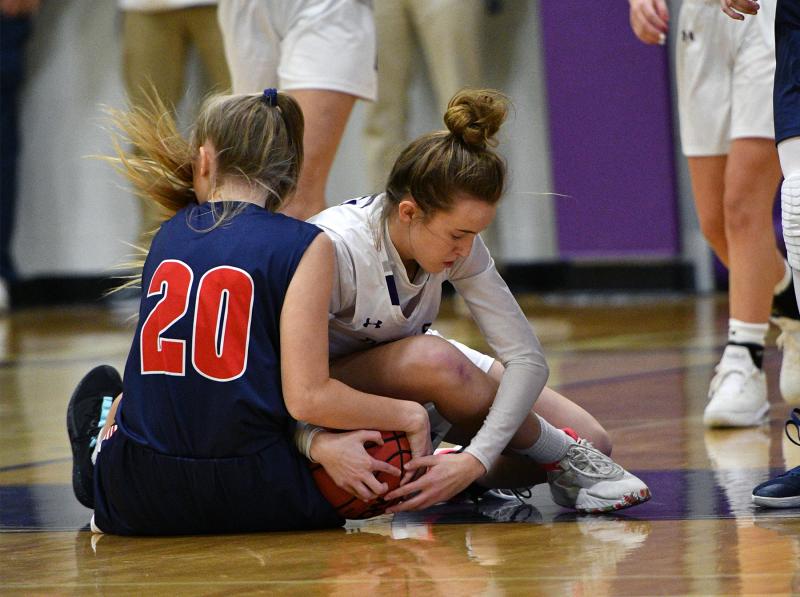 Royals junior Sara Walton, right, battles for a loose ball with Worcester’s Morgan White.
