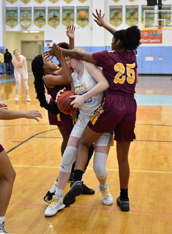 Cape senior forward Carlin Quinn gets crunched but successfully grabs one of her 14 rebounds in the contest.