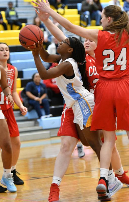 Cape junior varsity guard Ja'Onna Lee splits two Red Wolves defenders and scores two of her 11 points.
