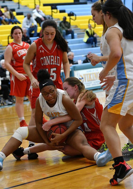 Cape forward Taonshaye Trader battles for a loose ball with a Red Wolves player in the Vikings JV victory.