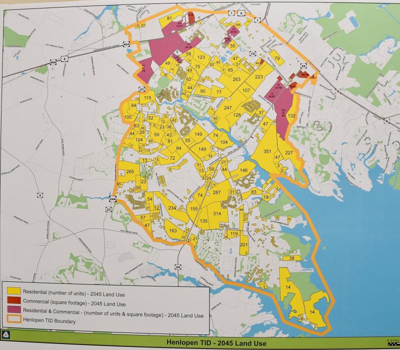 The yellow-shaded area shows the possible number of residential units and the red-shaded area shows possible commercial development in the transportation improvement district outlined in orange.