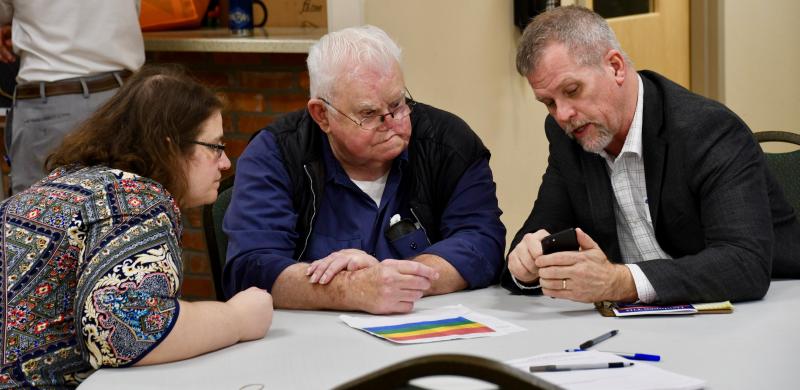 Sarah Coakley, DelDOT TID manager, left, and Drew Boyce, DelDOT director of planning, far right, discuss the proposed district with Greenwood resident Dan Kramer.