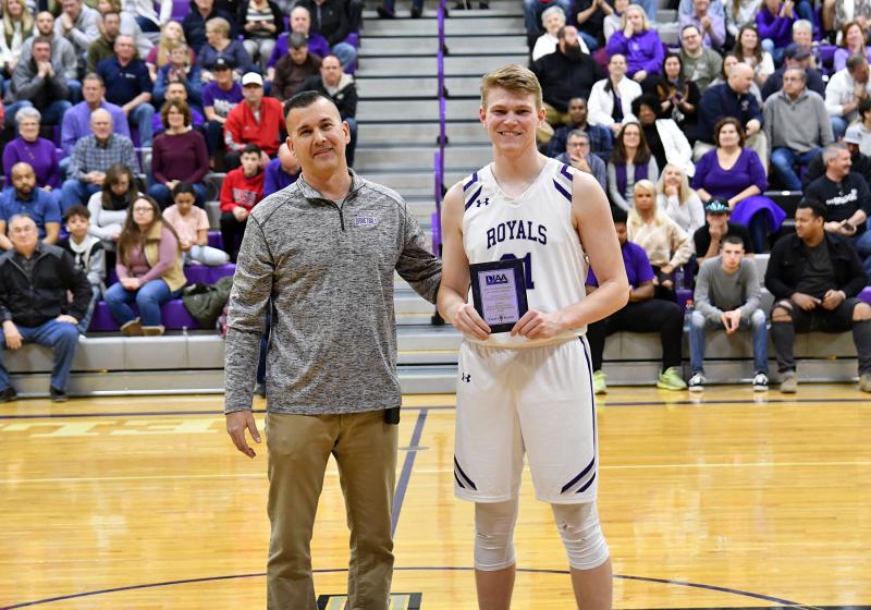 Royals senior forward Andrew Workman, right, receives the Crown Trophy Academic Award from Delmarva Christian Athletic Director Jim Berger.