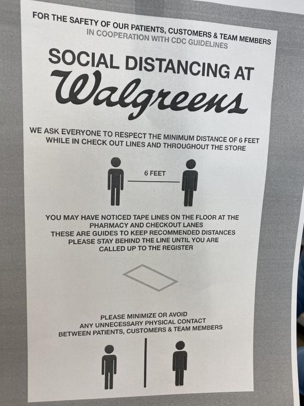 Walgreens reminds people to stay six feet apart. Black X’s marked where to stand. Deny Howeth Photo