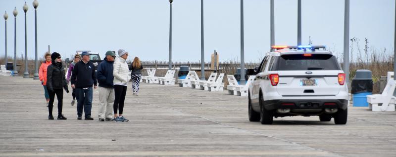 Rehoboth Beach police inform Boardwalk strollers that the boards and beach are closed. RON MACARTHUR PHOTO