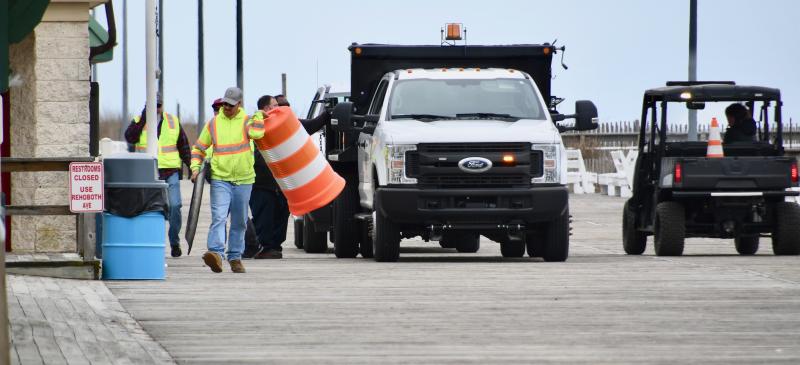 Rehoboth Beach workers place barrels on side streets to block pedestrians from access to the Boardwalk. RON MACARTHUR PHOTO