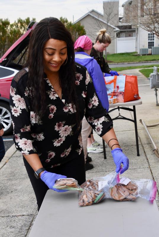 Lewes-Rehoboth Meals on Wheels coordinator Donna Hitchens lays out dog treats donated by Tail Bangers in Millsboro.