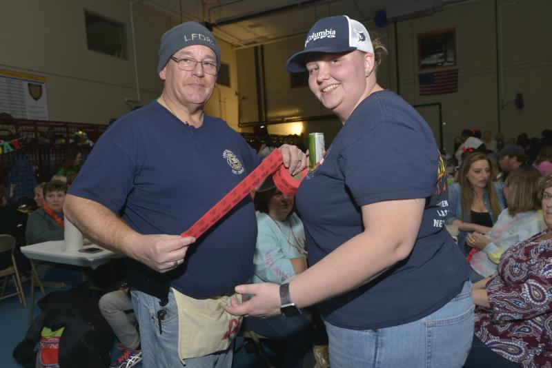 Selling raffle tickets for some great prizes are firefighters Brian Morley, left, and Lindsay Adams. Shrimp Feast 2020
