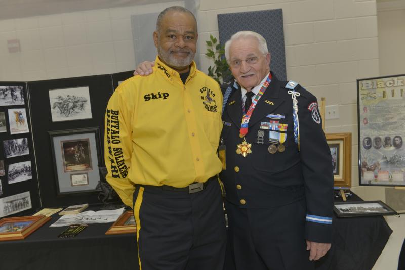 Skip Hutson, left, a member of the Buffalo Soldiers Delaware Motorcycle Club, and event speaker, shares a moment with event organizer Walter Koopman in front of the Buffalo Soldiers display. CHEER Black Culture Day