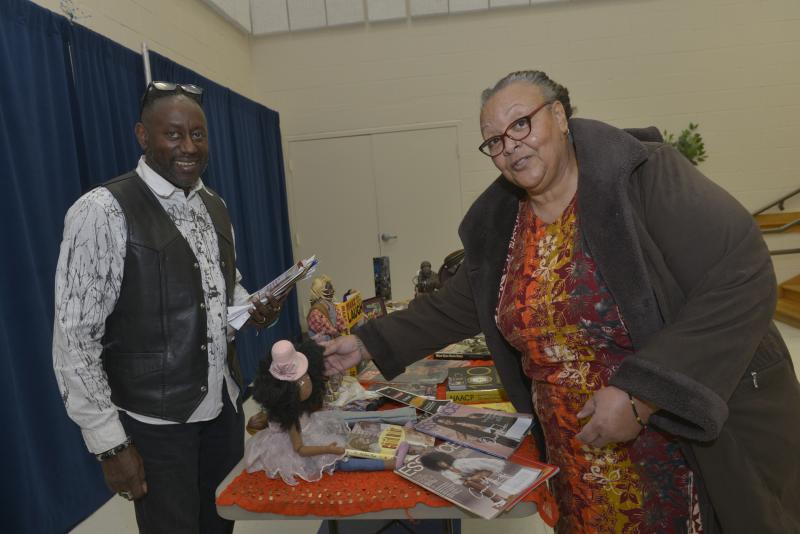 Ken Huff, shown without his friend Mr. Goodwood, smiles as Terri McNair expresses envy for the doll’s hair. CHEER Black Culture Day