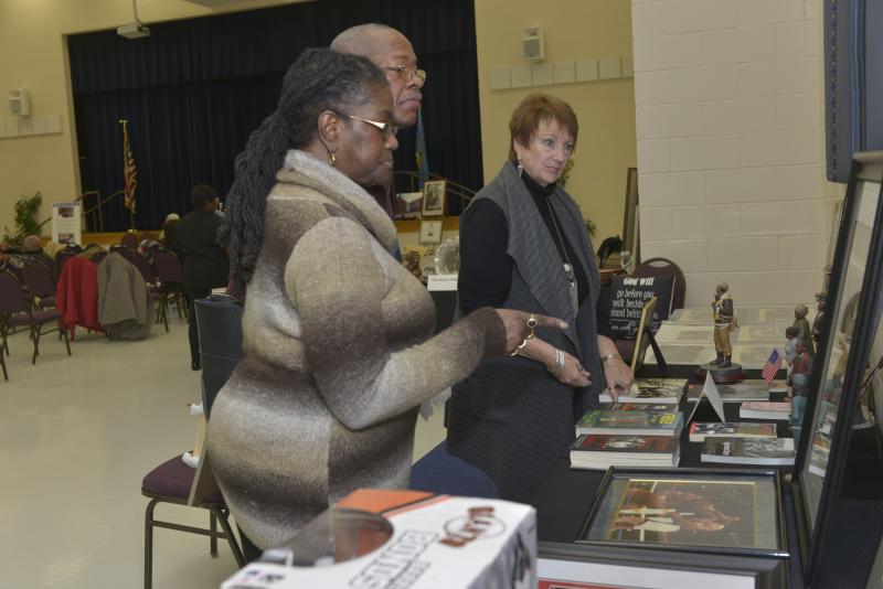 This display featured memorabilia from black sports and cultural heroes. Browsing the display are (l-r) Maryann Gardenhire, William Henton and Dee Blake. CHEER Black Culture Day