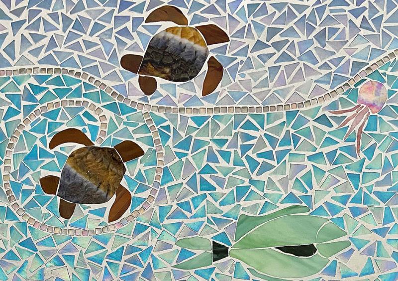 Volunteers are cutting mosaic tiles and stained-glass fish, gluing the pieces to substrate, grouting and sealing the mosaic, and will then secure the mural on the bridge. SUBMITTED PHOTOS