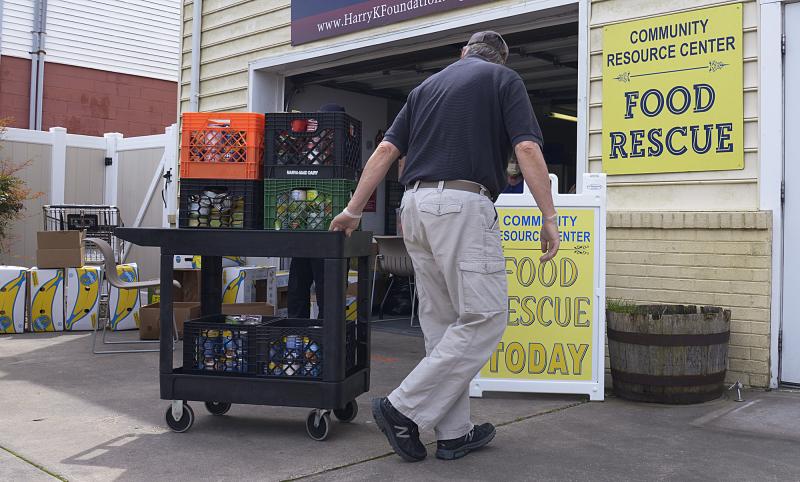 Rich Trzyzewski retrieves more items from storage to restock the shelves at the Cape Henlopen Food Basket on Oyster House Road in Rehoboth. DENY HOWETH PHOTOS