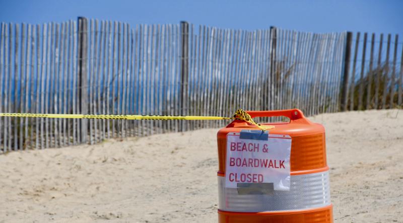 Signs, barrels, barricades and caution tape are reminders that the beach in Rehoboth and the Boardwalk are closed. RON MACARTHUR PHOTO