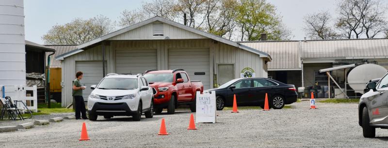 With the temperature at 70 degrees on April 7, a long line forms at Hopkins Farm Creamery near Lewes. The shop ended its drive-through service at 8 p.m. that night. RON MACARTHUR PHOTO